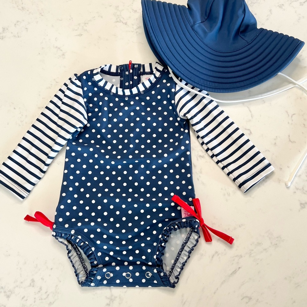 Ruffle Butts Navy Polka Dot Baby Swimsuit with Coordinating Hat, 6-12 months